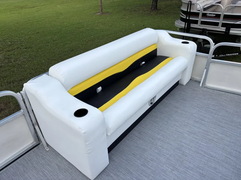 Slide: The Image of White and yellow boat seat on a 2007 Triton 220 Gold pontoon. - 11