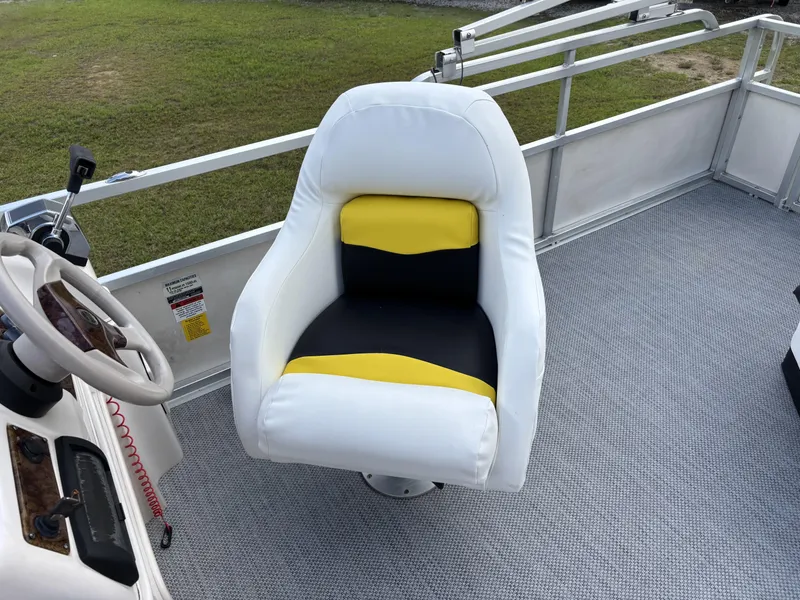Slide: The Image of Captain's chair on 2007 Triton 220 Gold boat, featuring white, black, and yellow upholstery. - 5