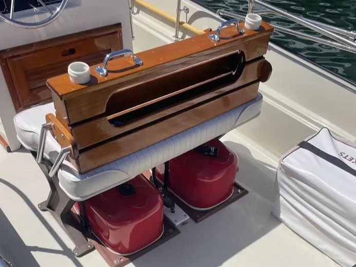 Slide: The Image of 1983 Boston Whaler 17 Montauk interior with wooden seat and red fuel tanks. - 2