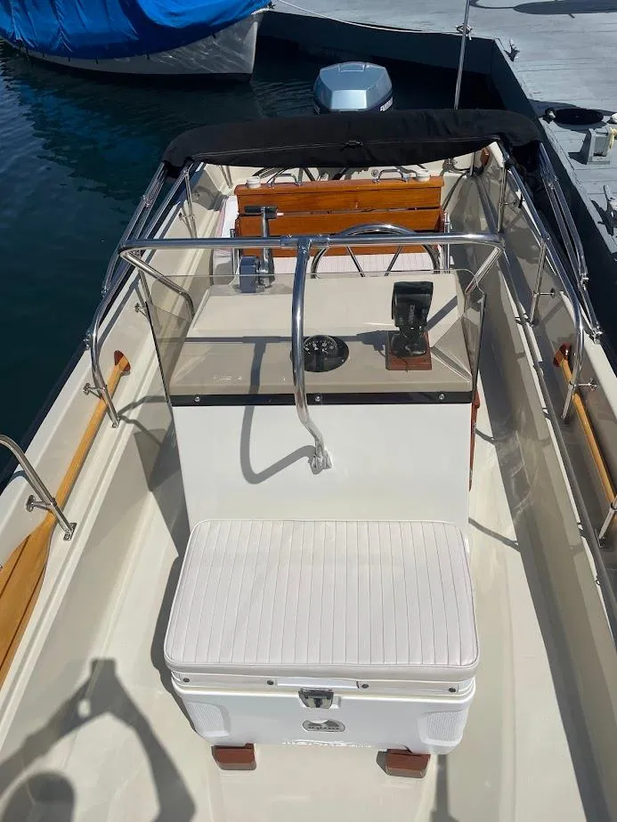 Slide: The Image of 1983 Boston Whaler 17 Montauk boat interior with steering console and seating. - 6