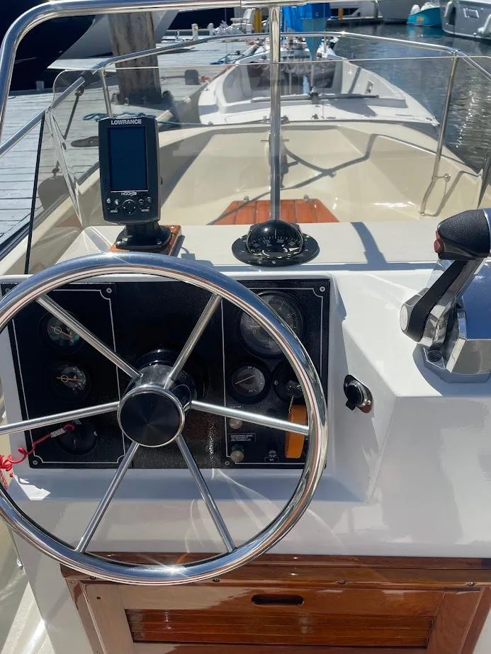 Slide: The Image of 1983 Boston Whaler 17 Montauk boat dashboard with steering wheel and controls. - 7
