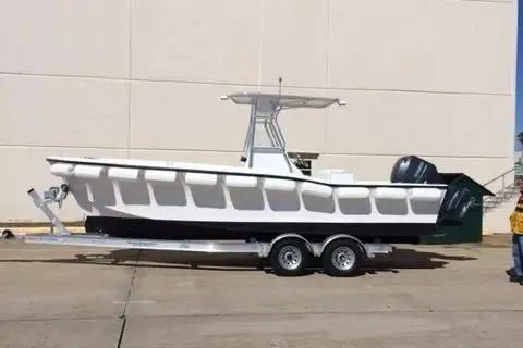 Slide: The Image of Custom 2024 pump out boat on trailer, parked outdoors. - 1