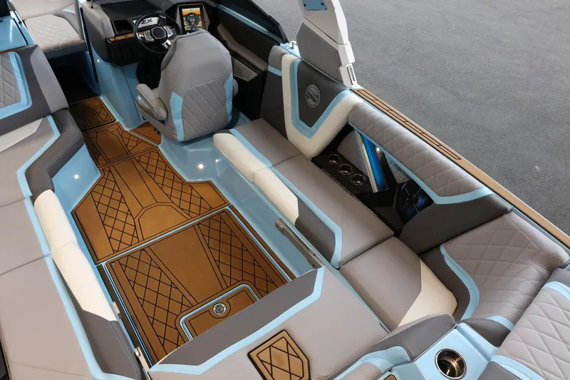 Slide: The Image of 2022 Tigé 25ZX boat interior with luxurious seating and modern dashboard design. - 13