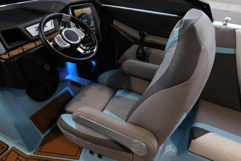 Slide: The Image of 2022 Tigé 25ZX boat interior with modern steering wheel and comfortable seating. - 15