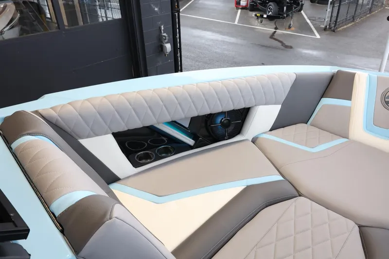 Slide: The Image of 2022 Tigé 25ZX boat interior with luxurious seating and cup holders. - 17