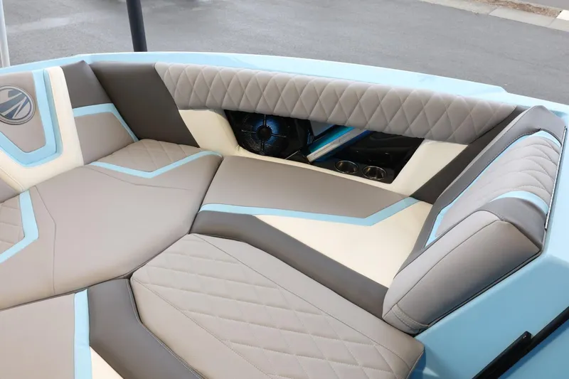 Slide: The Image of 2022 Tigé 25ZX boat interior with stylish gray and blue seating. - 18