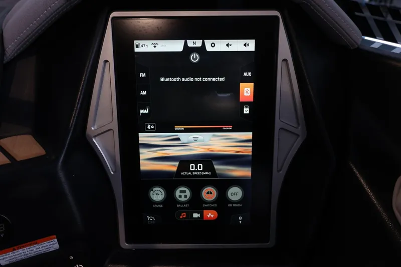 Slide: The Image of Touchscreen display in 2022 Tigé 25ZX boat showing audio and navigation controls. - 28