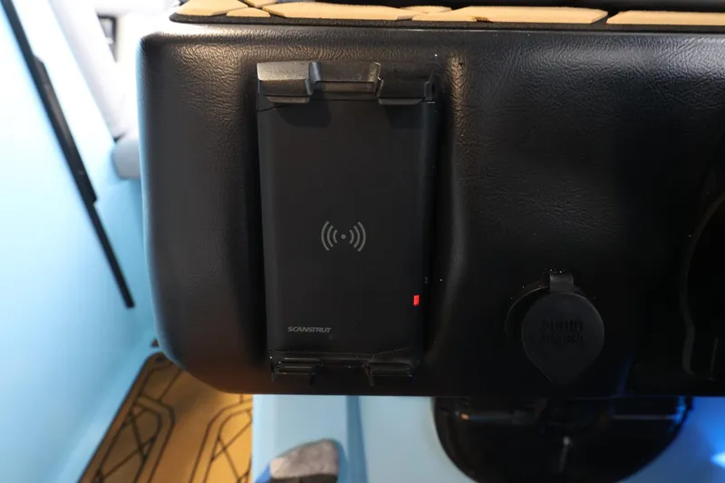 Slide: The Image of 2022 Tigé 25ZX dashboard with wireless charging pad and power outlet. - 31