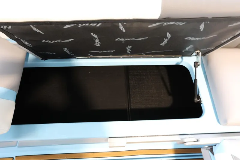 Slide: The Image of 2022 Tigé 25ZX boat storage compartment with open lid, showcasing interior space. - 35
