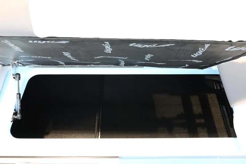 Slide: The Image of Open storage compartment in 2022 Tigé 25ZX boat. - 36