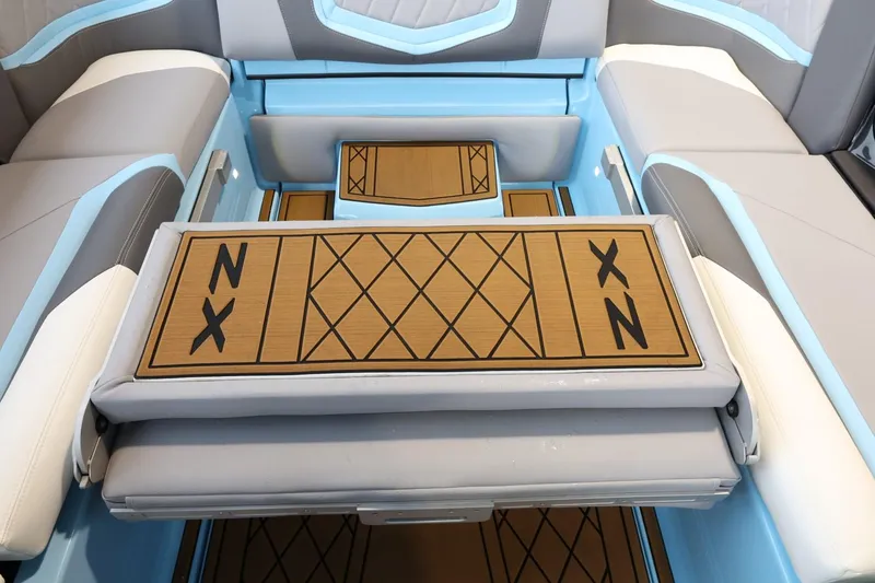 Slide: The Image of 2022 Tigé 25ZX boat interior with blue and gray seating and custom flooring. - 37