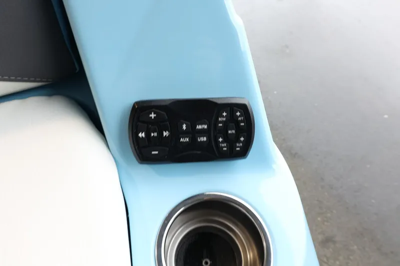 Slide: The Image of Control panel and cup holder in 2022 Tigé 25ZX boat interior. - 39