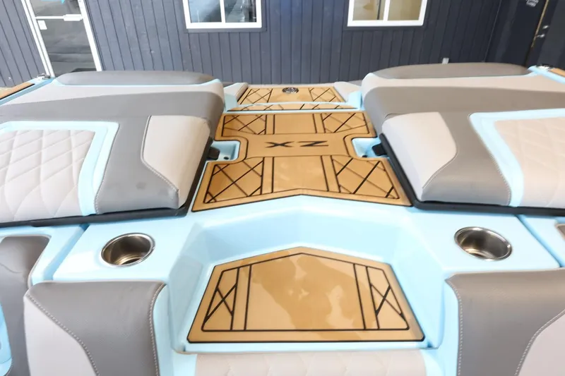 Slide: The Image of 2022 Tigé 25ZX boat interior with cushioned seating and cup holders. - 40