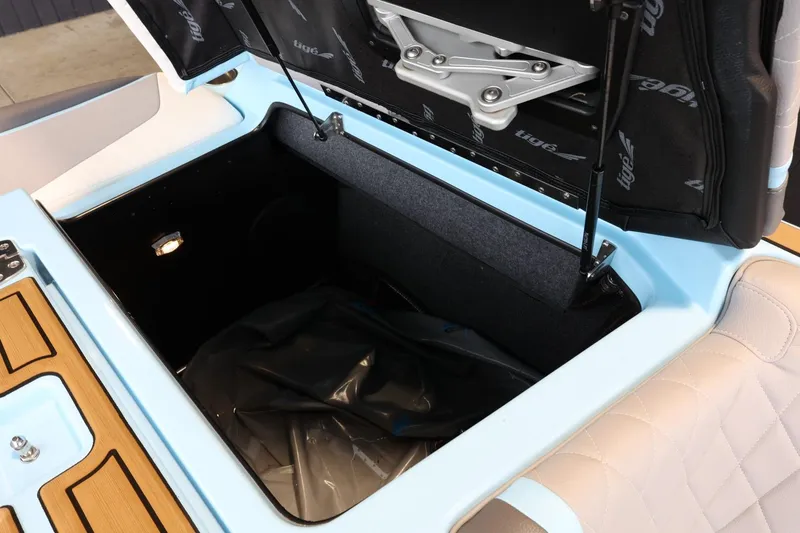 Slide: The Image of 2022 Tigé 25ZX boat storage compartment with open lid, showcasing spacious interior. - 41