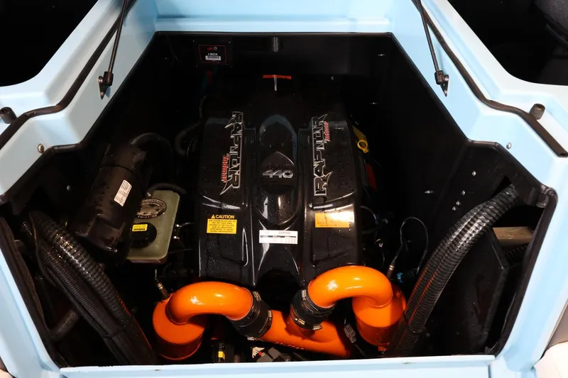 Slide: The Image of 2022 Tigé 25ZX boat engine compartment with Raptor motor and orange hoses. - 43