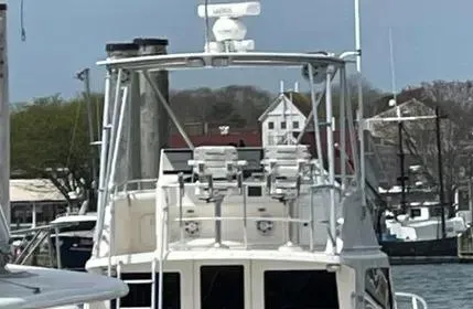 Slide: The Image of 2005 Cabo 35 Flybridge Sportfisher docked at a marina with scenic background. - 10