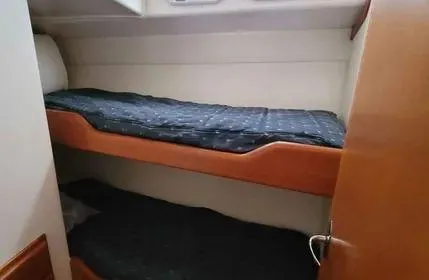 Slide: The Image of 2005 Cabo 35 Flybridge Sportfisher cabin with bunk beds and wooden finishes. - 15