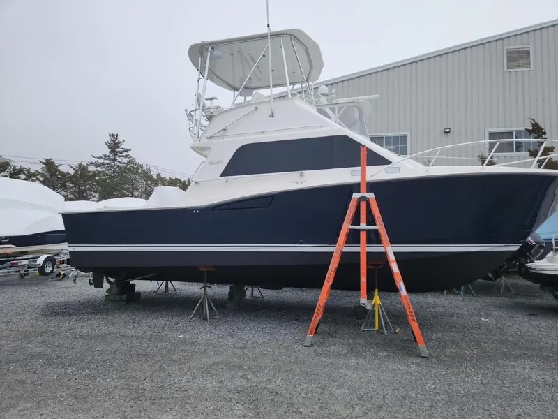 Slide: The Image of 2005 Cabo 35 Flybridge Sportfisher boat on stands, outdoor storage area. - 2