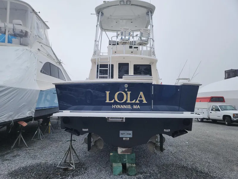 Slide: The Image of 2005 Cabo 35 Flybridge Sportfisher named "Lola" in Hyannis, MA, on a boatyard stand. - 4