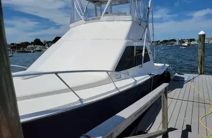 Slide: The Image of 2005 Cabo 35 Flybridge Sportfisher docked by the water on a sunny day. - 5