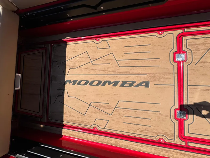 Slide: The Image of 2022 Moomba Makai boat interior with stylish flooring and red accents. - 20
