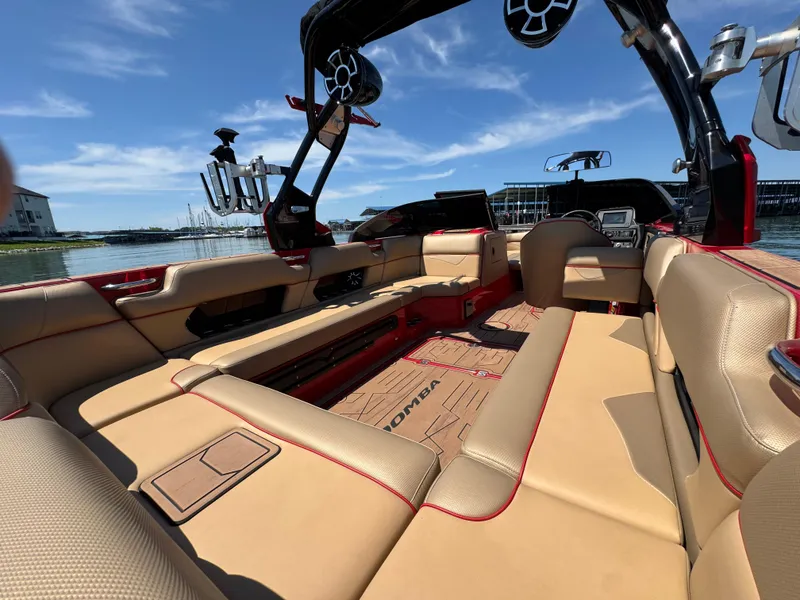 Slide: The Image of 2022 Moomba Makai boat interior with beige seating and modern design on a sunny day. - 21