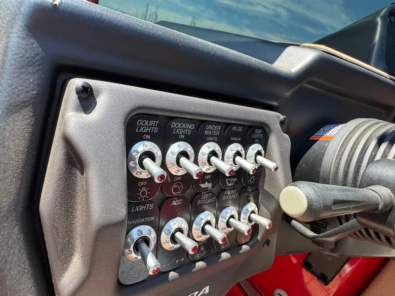 Slide: The Image of Control panel of a 2022 Moomba Makai boat with various switches. - 29