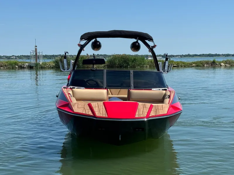 Slide: The Image of 2022 Moomba Makai boat on calm water, featuring a sleek red and black design. - 3