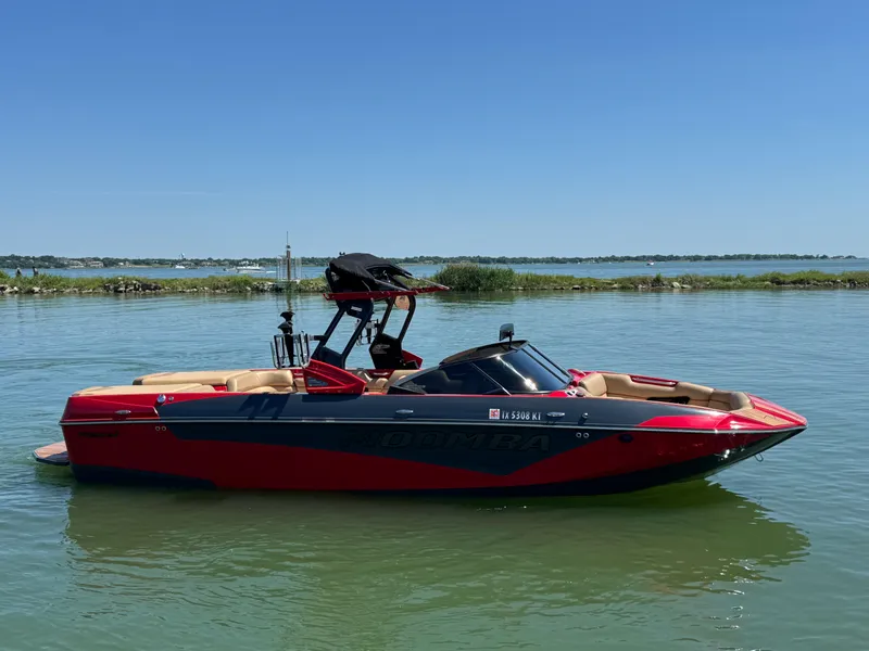 Slide: The Image of 2022 Moomba Makai boat in vibrant red on a calm lake. - 4