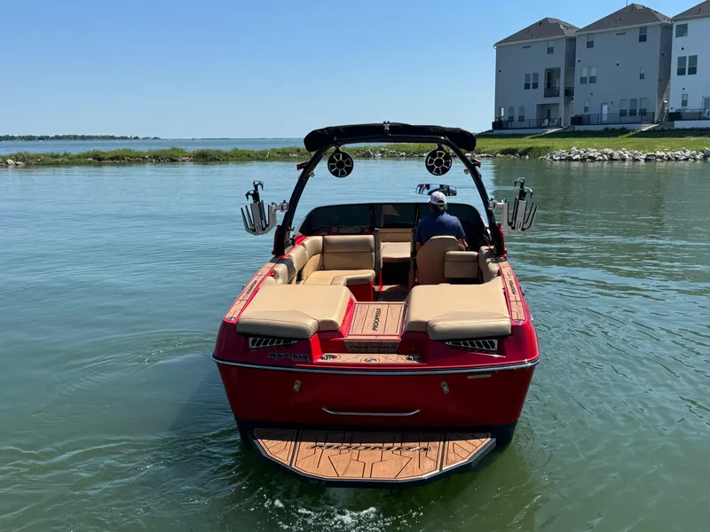 Slide: The Image of 2022 Moomba Makai boat on water near residential buildings. - 6