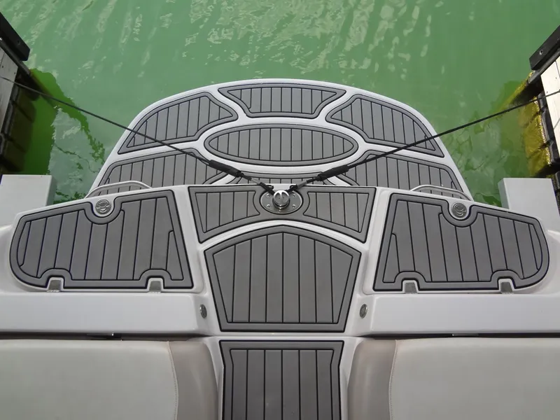 Slide: The Image of 2008 Correct Craft Super Air Nautique 230 in dock, yellow and black hull, front view. - 11