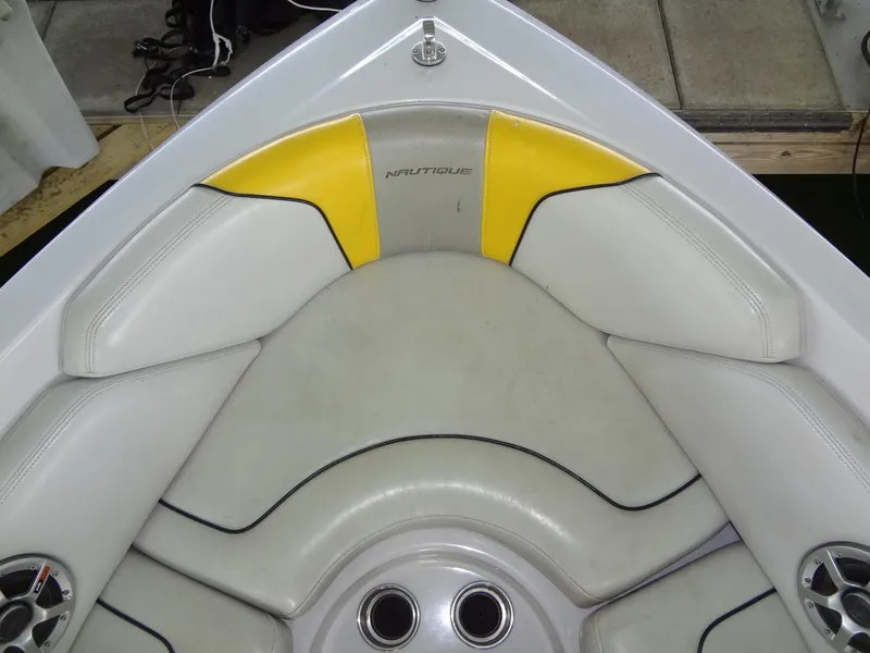 Slide: The Image of 2008 Correct Craft Super Air Nautique 230 boat docked in a covered marina. - 13