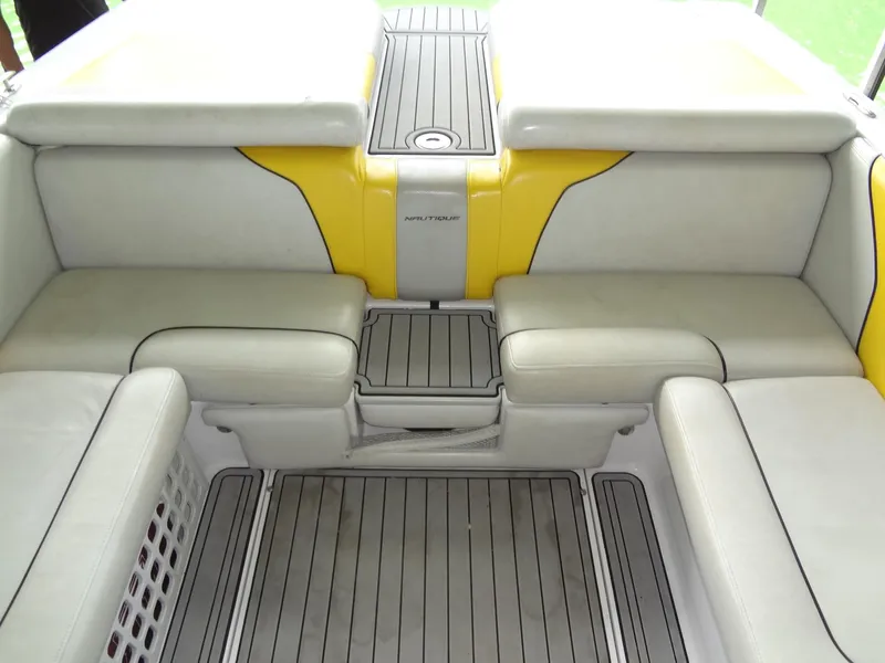 Slide: The Image of 2008 Correct Craft Super Air Nautique 230 interior with yellow and white seating. - 18