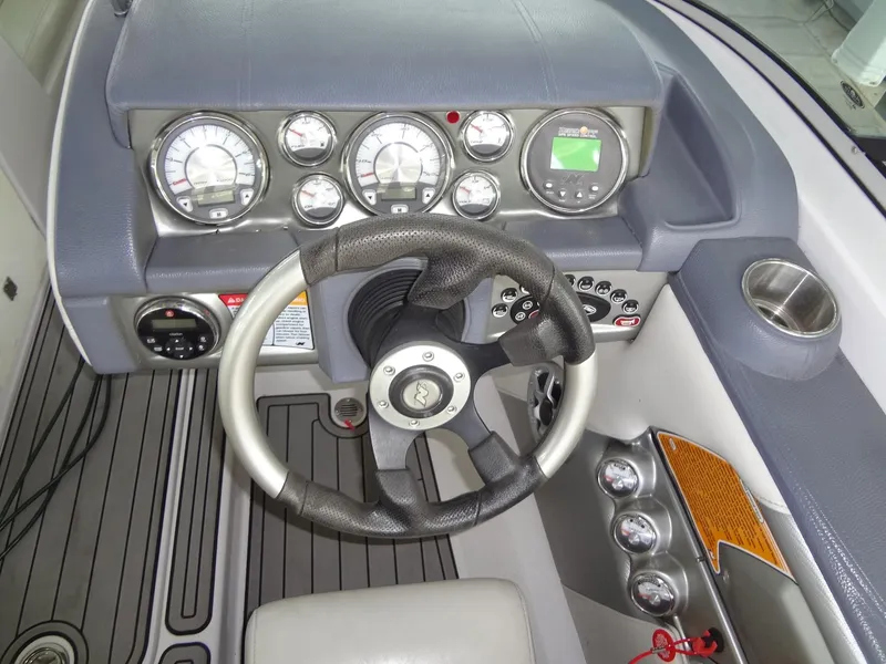 Slide: The Image of 2008 Correct Craft Super Air Nautique 230 interior seating with yellow accent and speaker. - 22