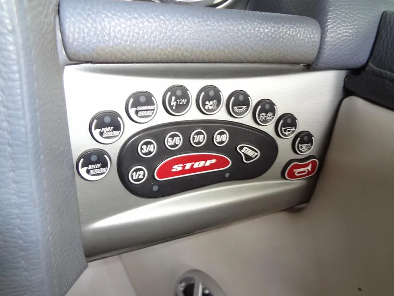 Slide: The Image of 2008 Correct Craft Super Air Nautique 230 interior with yellow and white seating, cup holders. - 25