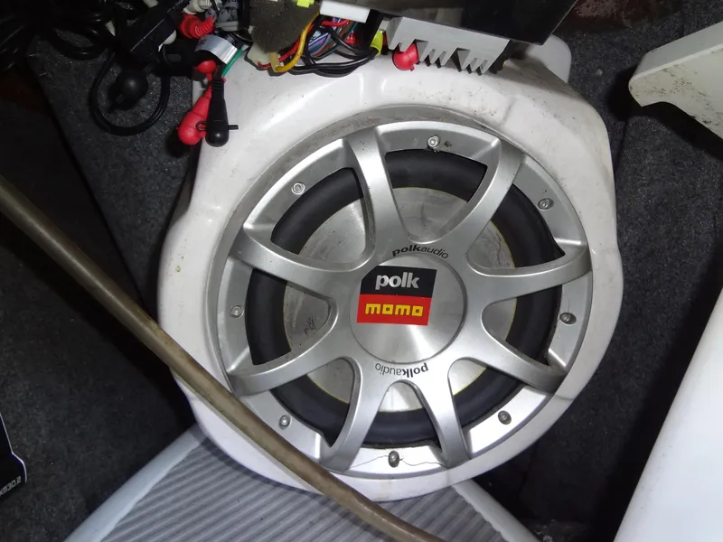 Slide: The Image of 2008 Correct Craft Super Air Nautique 230 interior seating with yellow accents and gray flooring. - 28