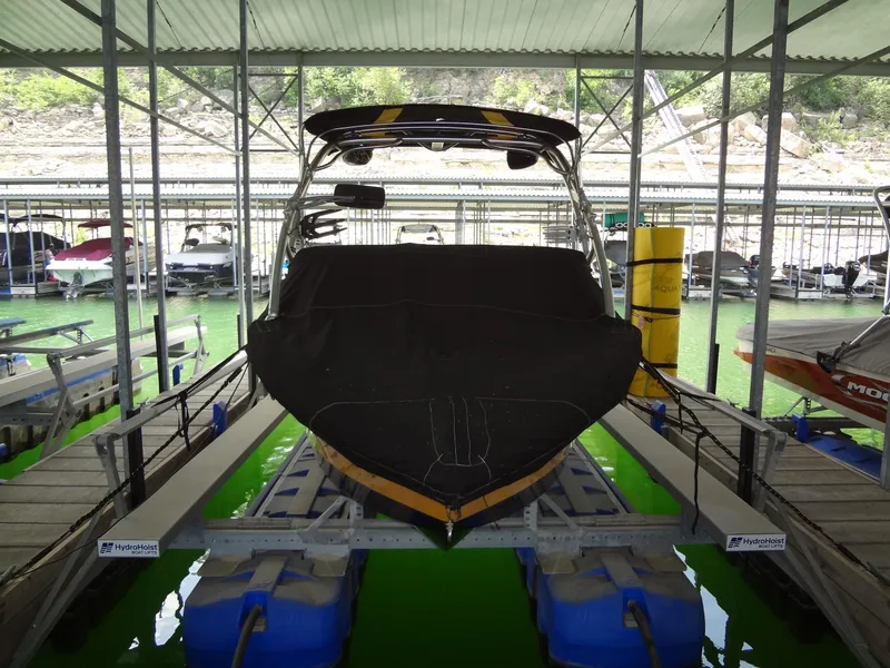 Slide: The Image of 2008 Correct Craft Super Air Nautique 230 boat docked in covered marina. - 41