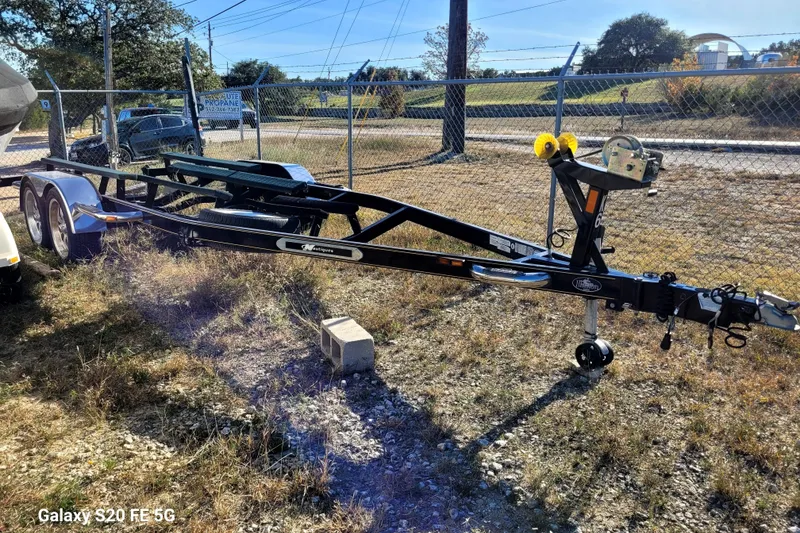 Slide: The Image of Trailer for 2008 Correct Craft Super Air Nautique 230, parked outdoors on grass. - 43