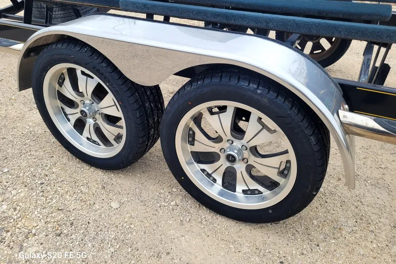 Slide: The Image of Trailer wheels for 2008 Correct Craft Super Air Nautique 230 on gravel surface. - 44