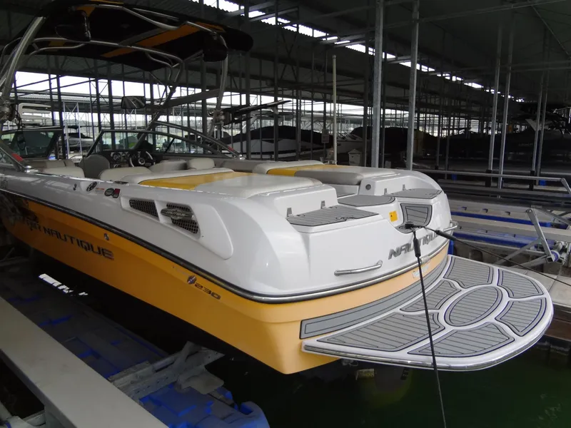 Slide: The Image of 2008 Correct Craft Super Air Nautique 230 interior with yellow and white seating. - 5