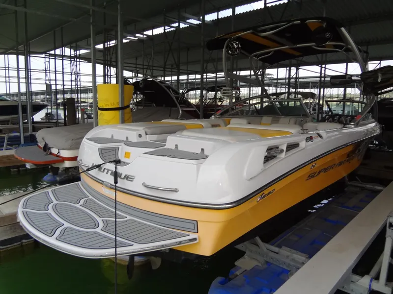 Slide: The Image of 2008 Correct Craft Super Air Nautique 230 interior with yellow and gray seating. - 6
