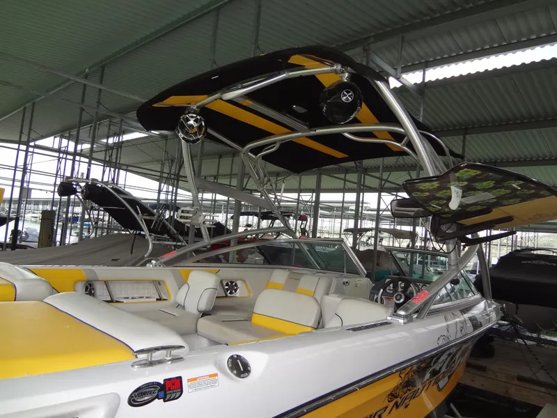 Slide: The Image of 2008 Correct Craft Super Air Nautique 230 interior with yellow and gray seating. - 7