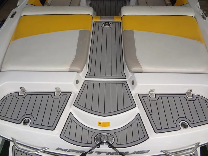 Slide: The Image of 2008 Correct Craft Super Air Nautique 230 boat in marina, front view, docked on lift. - 9