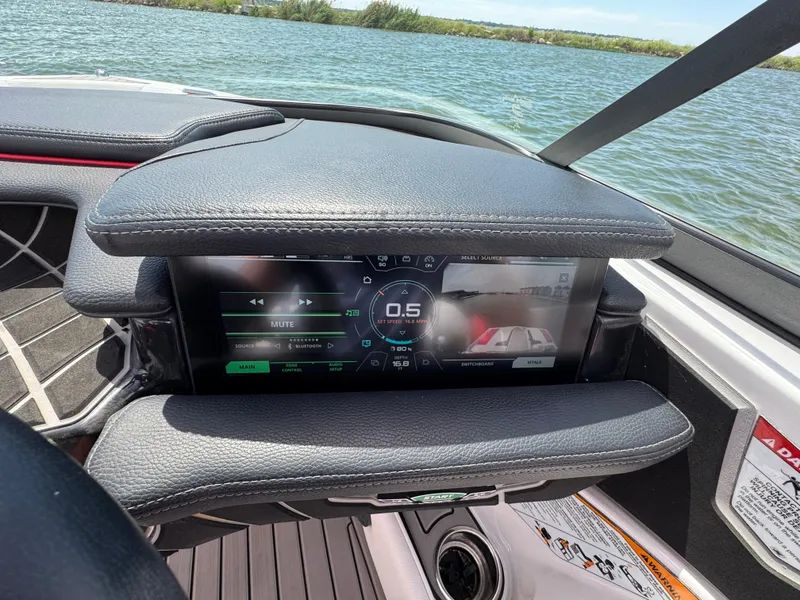 Slide: The Image of Dashboard of 2018 Nautique Super Air Nautique 210 boat with digital display on a lake. - 15