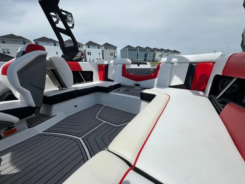 Slide: The Image of 2018 Nautique Super Air Nautique 210 interior with red and white seating, modern design. - 17