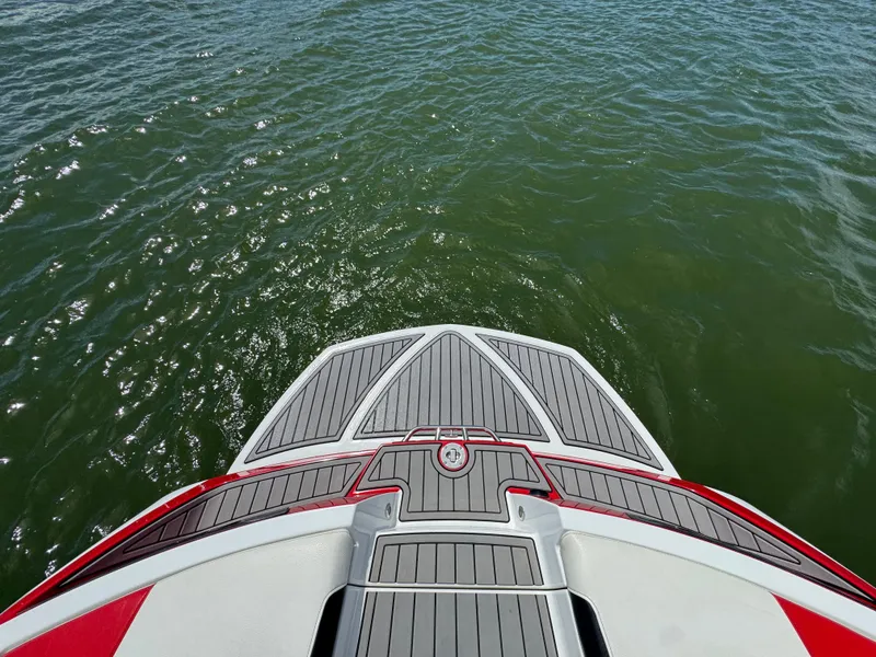 Slide: The Image of 2018 Nautique Super Air Nautique 210 boat deck overlooking water. - 23