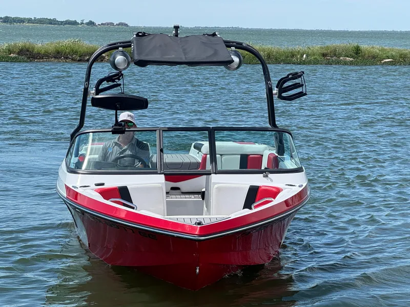 Slide: The Image of 2018 Nautique Super Air Nautique 210 boat on water, red and white design, with wakeboard tower. - 3