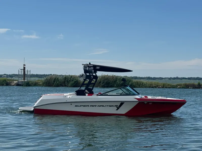 Slide: The Image of 2018 Nautique Super Air Nautique 210 boat on calm water, side view. - 4