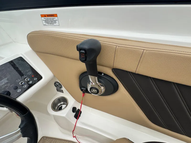 Slide: The Image of 2019 Sea Ray SPX 230 boat throttle control and dashboard detail. - 12