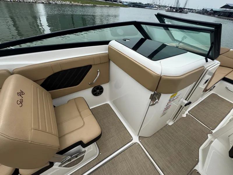 Slide: The Image of 2019 Sea Ray SPX 230 boat interior with tan seating and sleek design. - 13